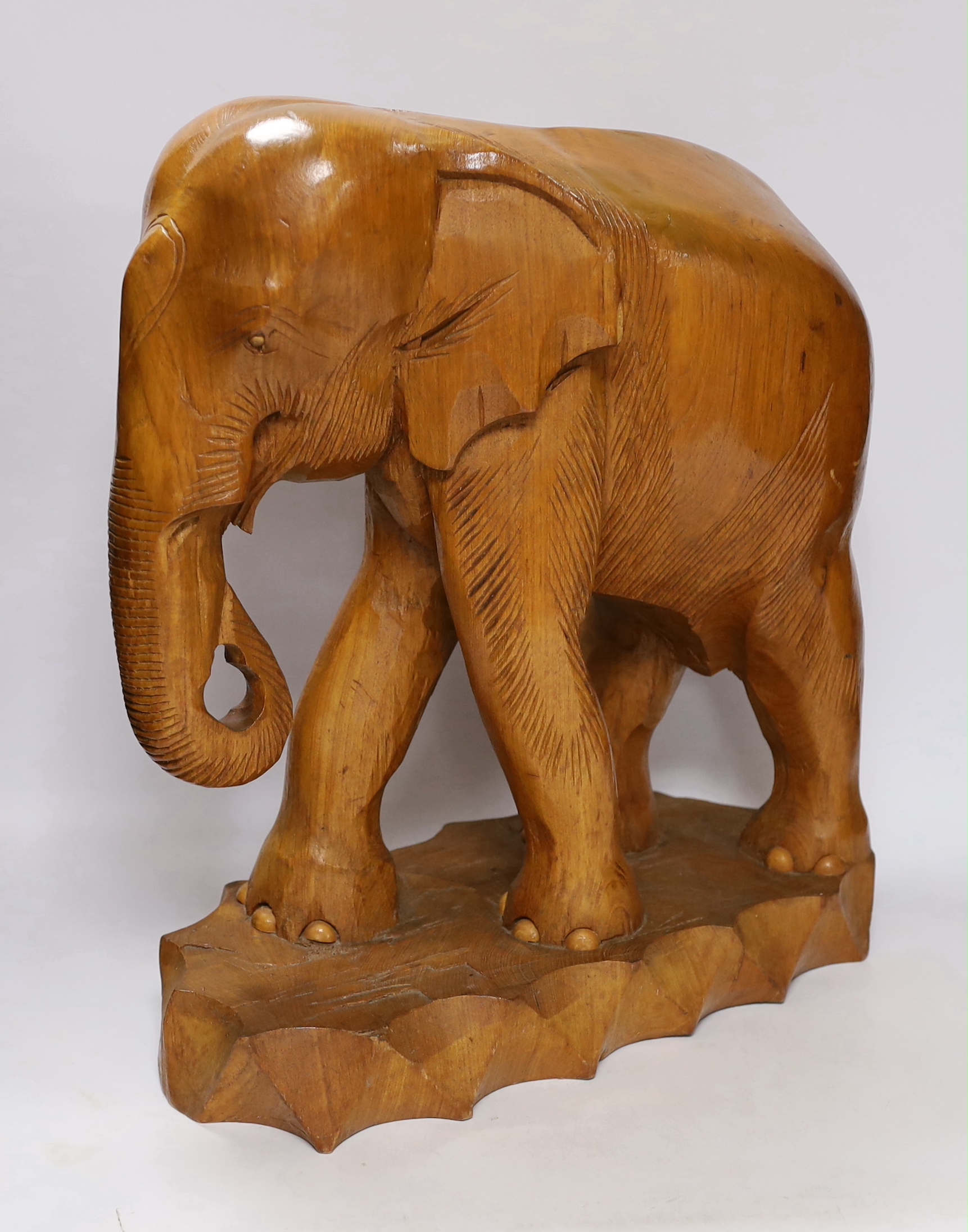 A pair of carved elephants, 42cm high